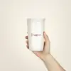 taza termo personalizada con logo fondo beige modelo mano