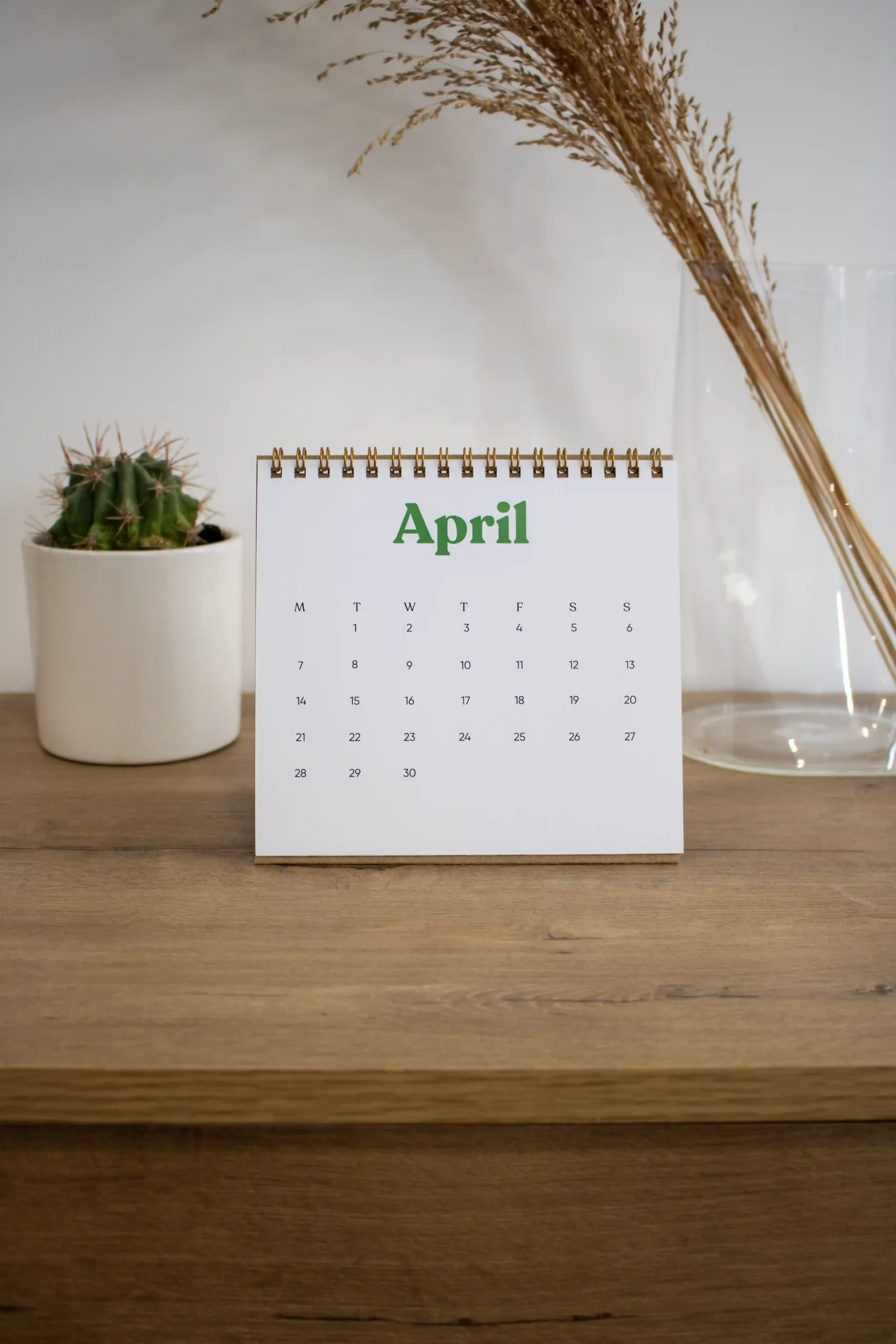 Calendario triangular de mesa personalizado sobre una mesa de madera