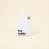 Porta llaves de hotel en papel ecológico blanco personalizado con la palabra key holder en azul