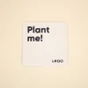Posavasos de cartón personalizado con el texto 'plant me' y 'logo' en color azil