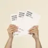 Dos manos sujetando 3 cuadernos plantables blancos personalizados con el texto 'Nature guides our steps'