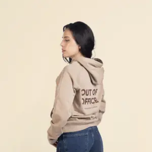 Chica morena de perfil llevando jeans y una sudadera con capucha beige personalizada