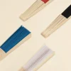 Cuatro abanicos de colores con varillas de madera y tela poliester cerrados