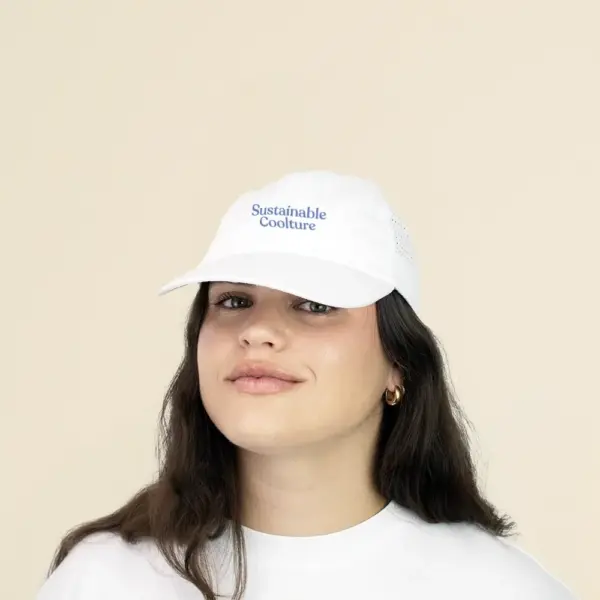 Chica con una gorra personalizable con visera deportiva sobre un fondo beige