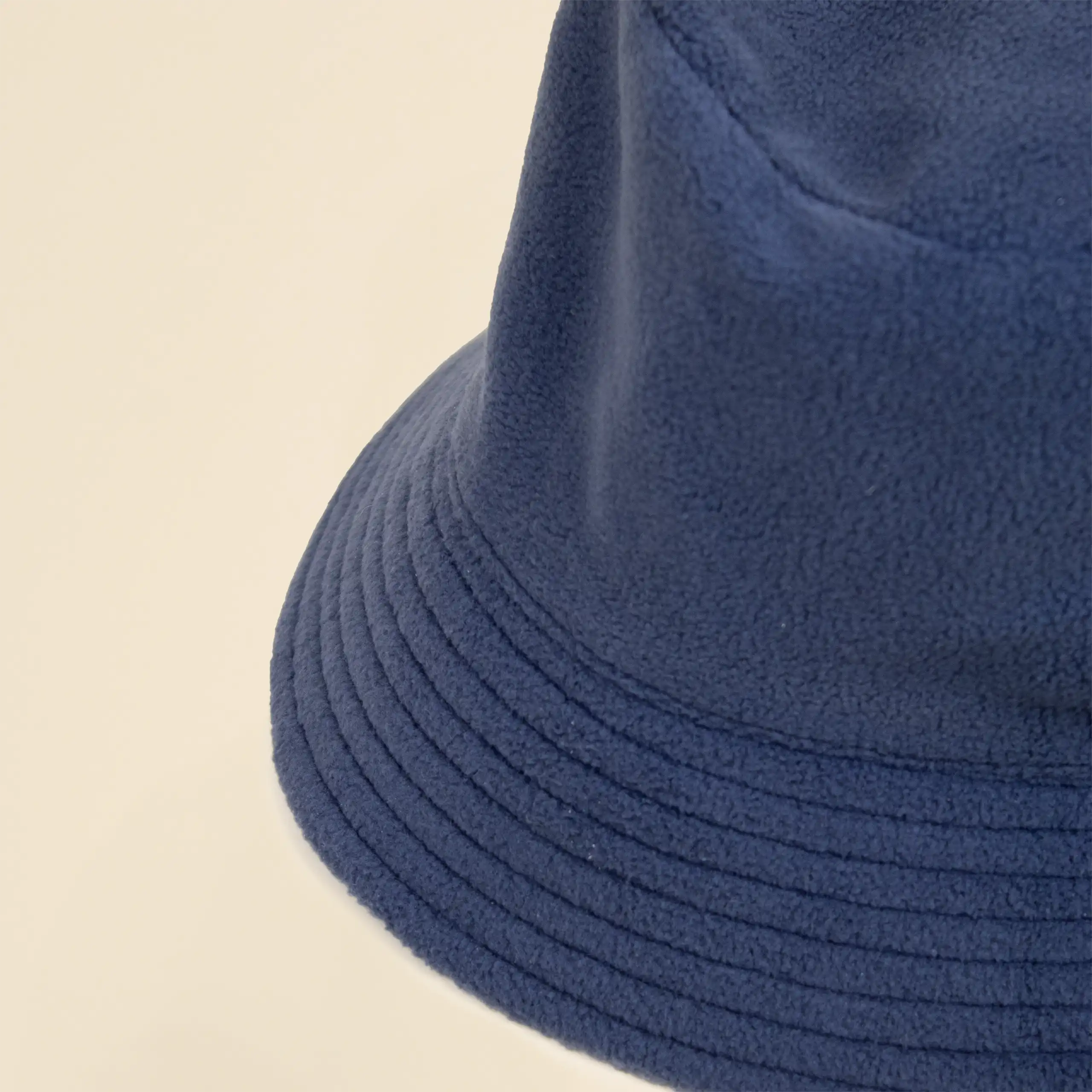 Gorro TWIST azul Gorro azul impermeable reversible ecológico personalizado sobre un fondo beige