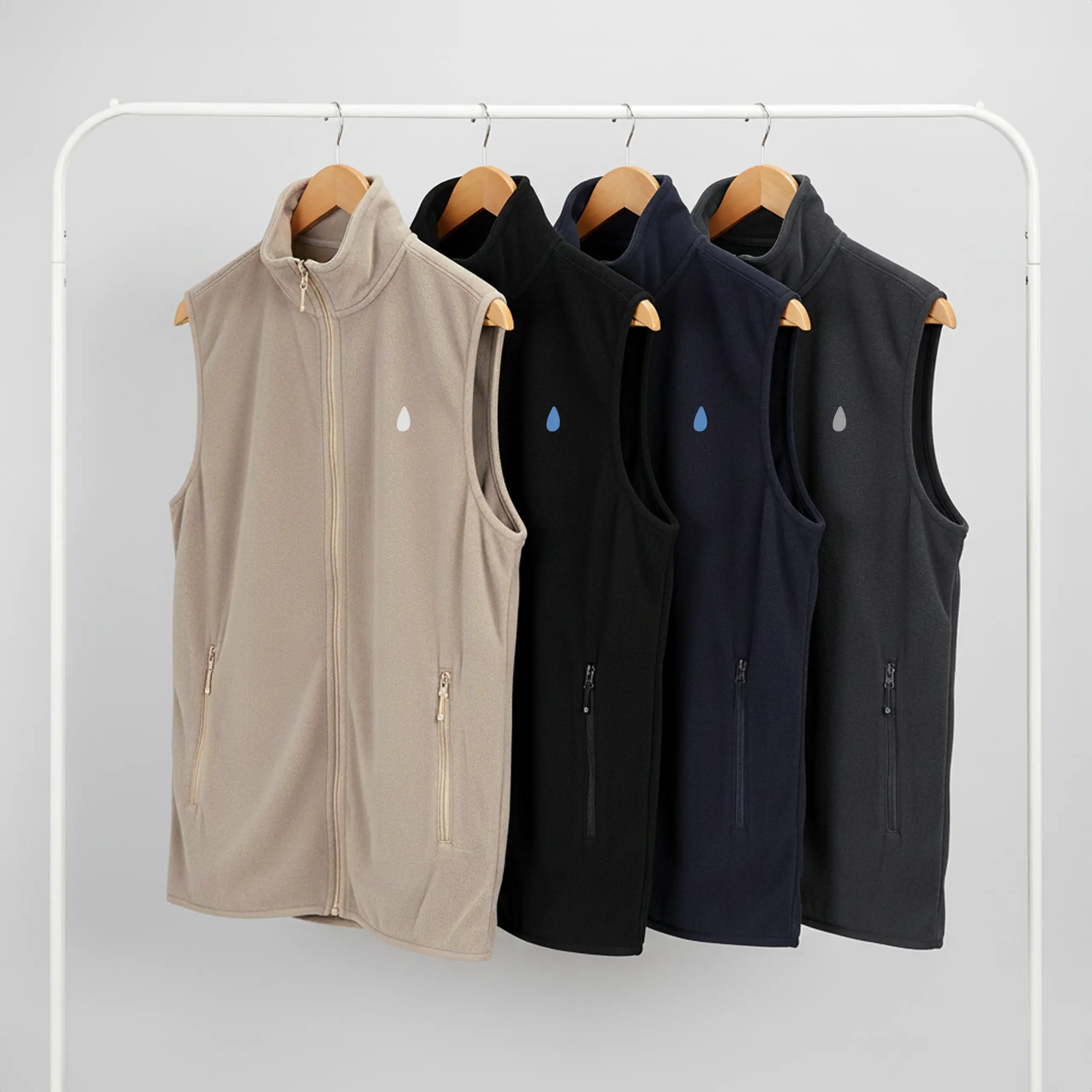 4 chalecos polares personalizados de cuatro colores colgados sobre perchas