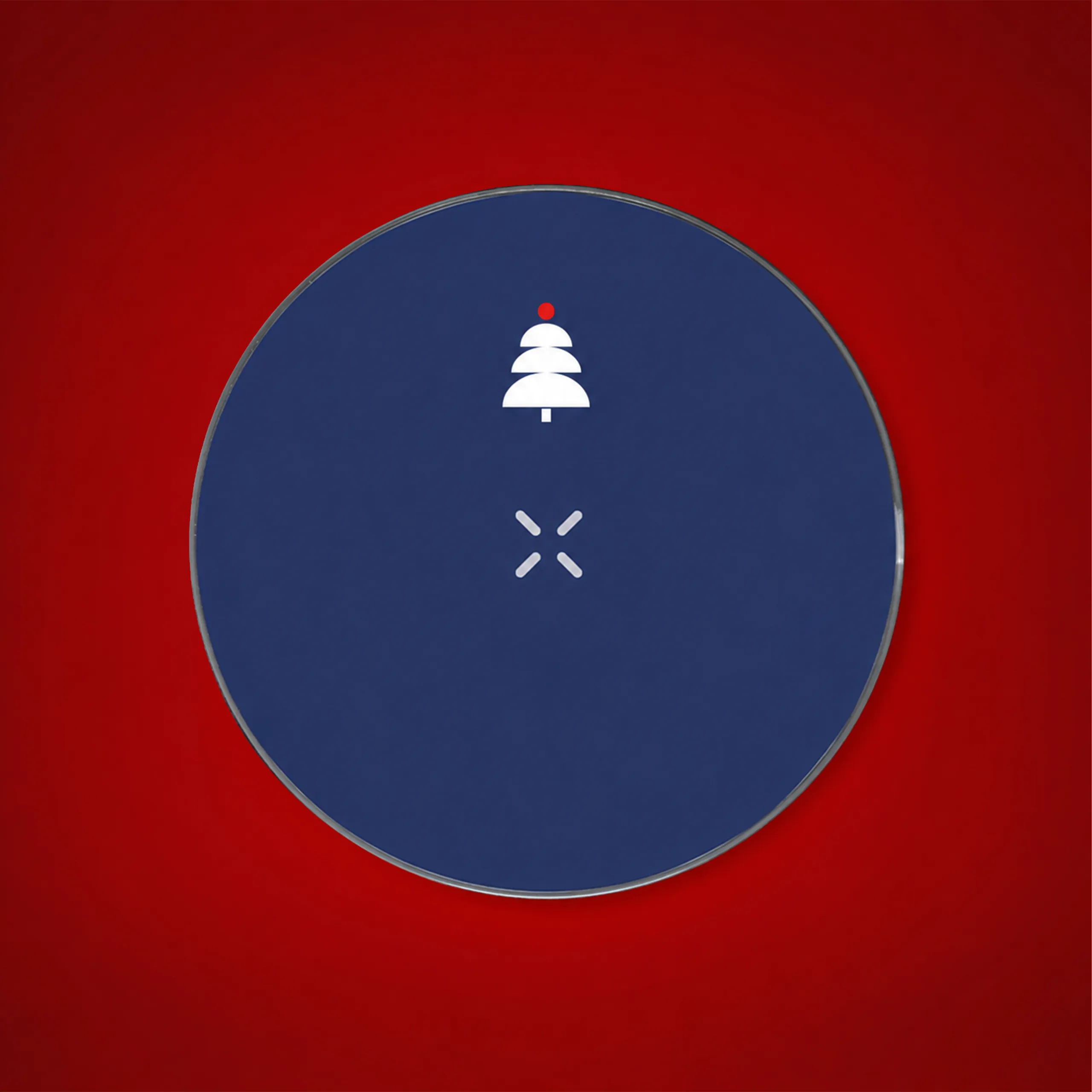 Customised round wireless charger in navy blue with a white Christmas tree and a lightning bolt icon, against a red backdrop.