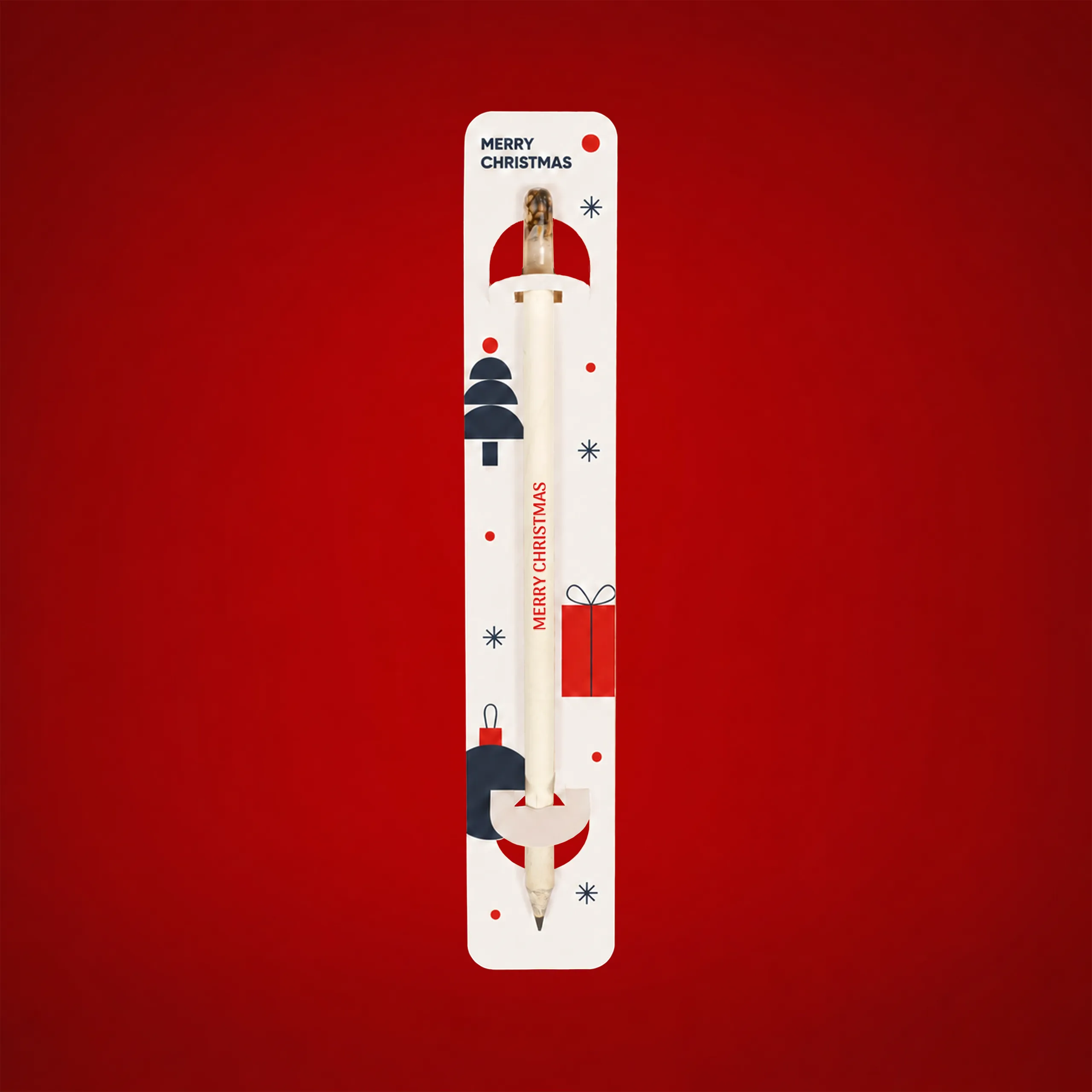 Lápiz plantable personalizado en su blíster decorado con motivos navideños, mostrando el texto "Merry Christmas" impreso verticalmente en el lápiz, sobre fondo rojo.