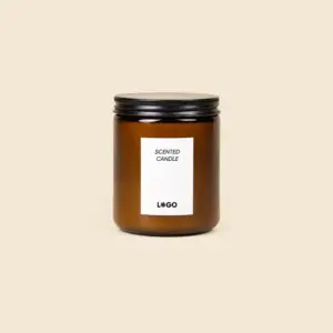 Eco-friendly soy candle in an amber glass jar with black metal lid, customisable label with logo, beige background.
