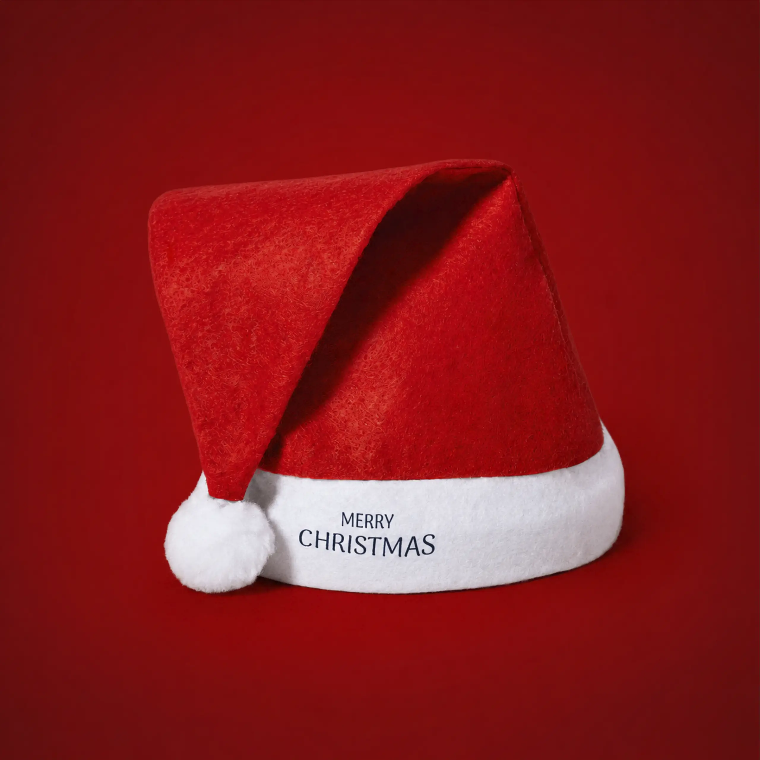 Personalised Santa hat on a red background, with the "Merry Christmas" message embroidered on the white trim.