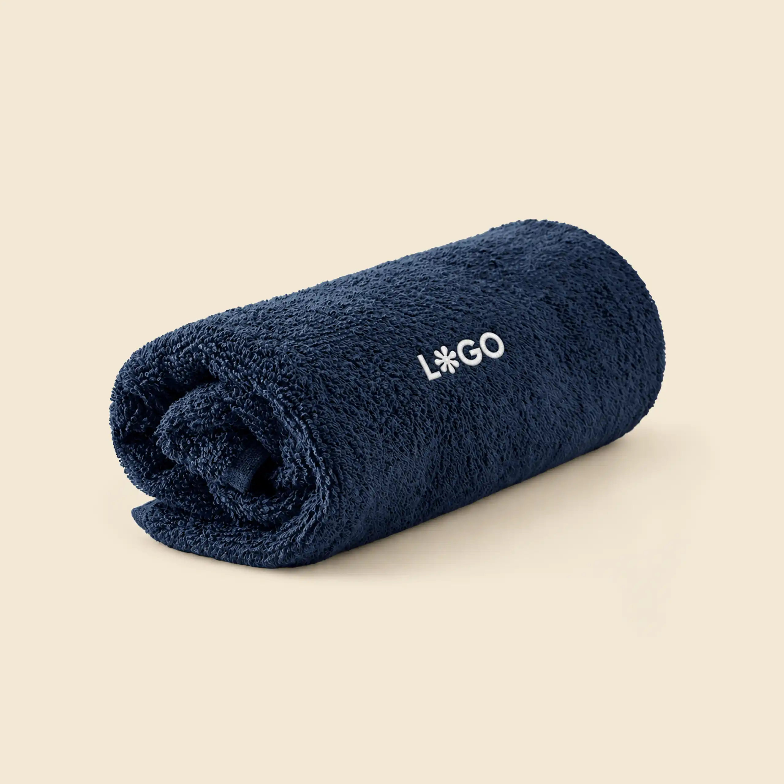 Navy personalised bath towel rolled up, with white embroidered logo