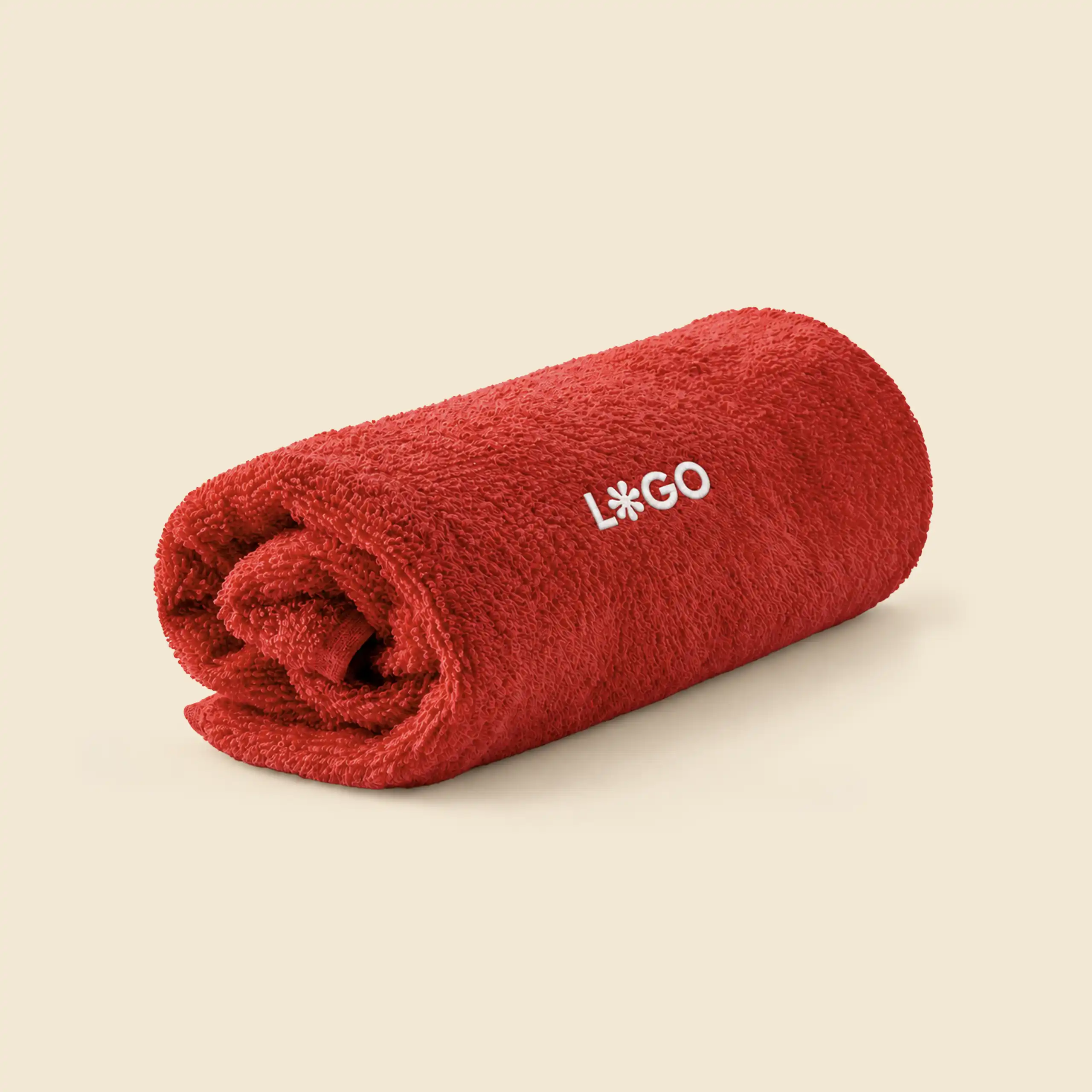 Red personalised bath towel rolled up, with white embroidered logo