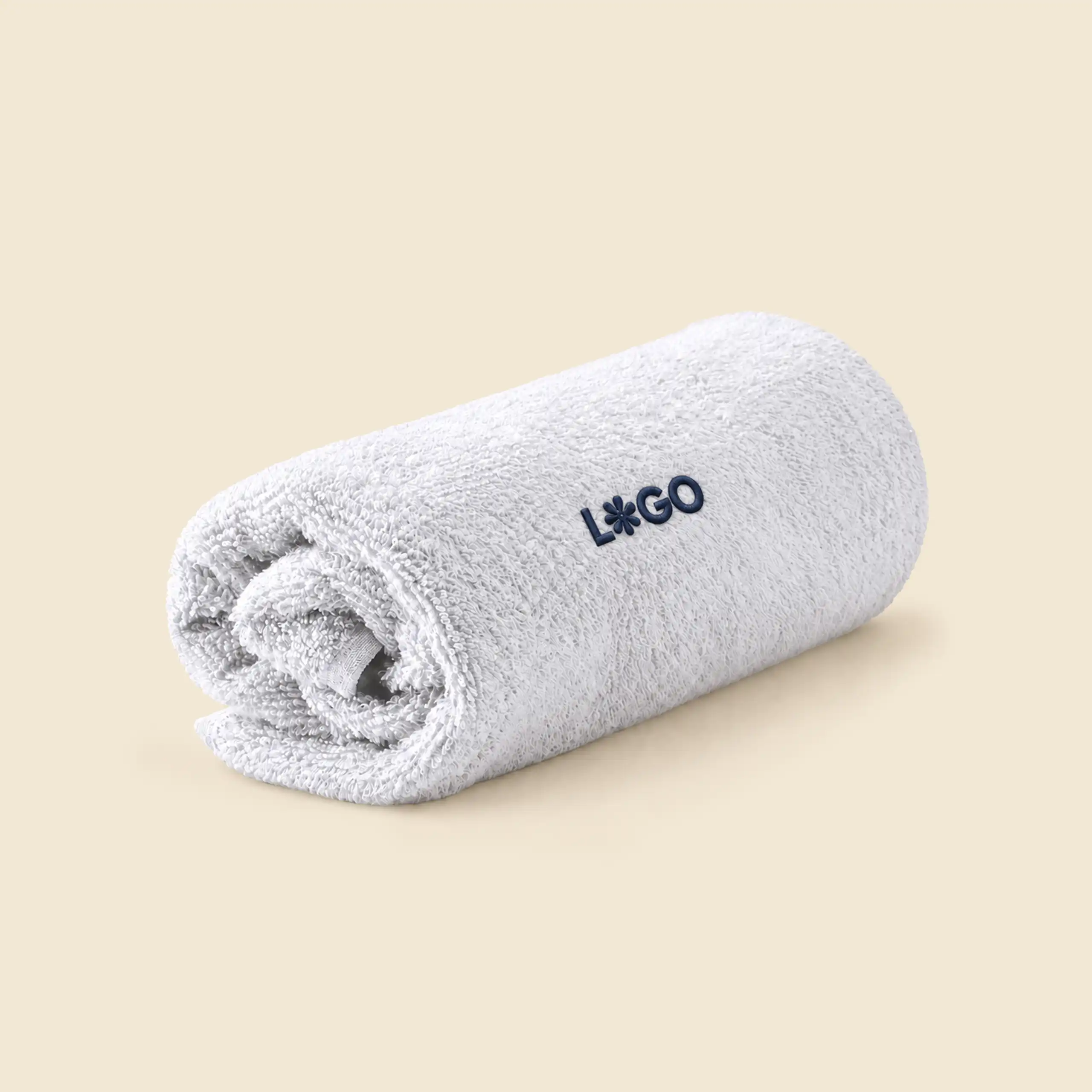 White personalised bath towel rolled up, with navy embroidered logo